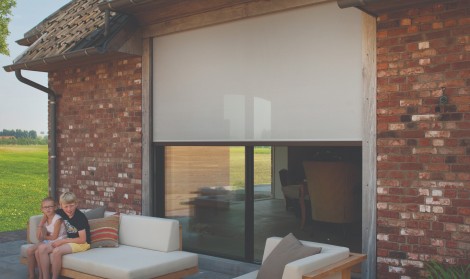 Brustor B-1200 patio roller shade installed over sliding doors