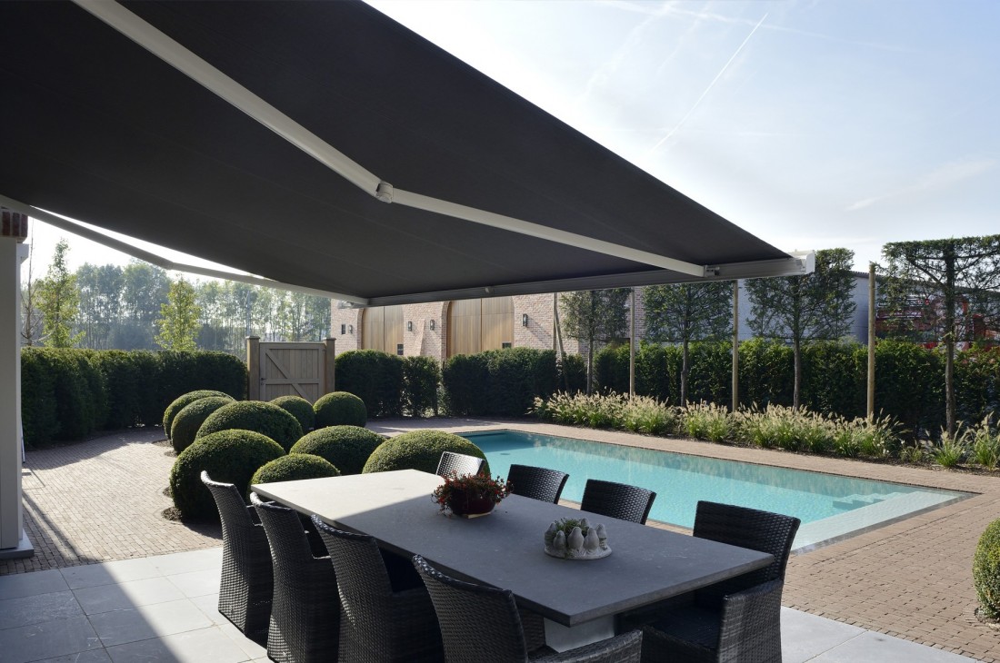 House awning over dining terrace and pool