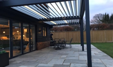 Black Pergola on Stone Patio