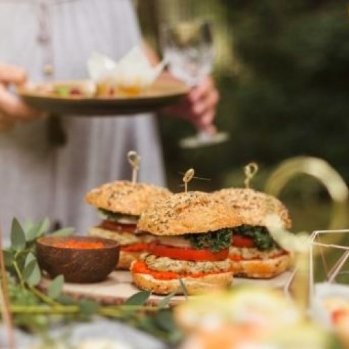 Woman enjoying food at a garden party. 