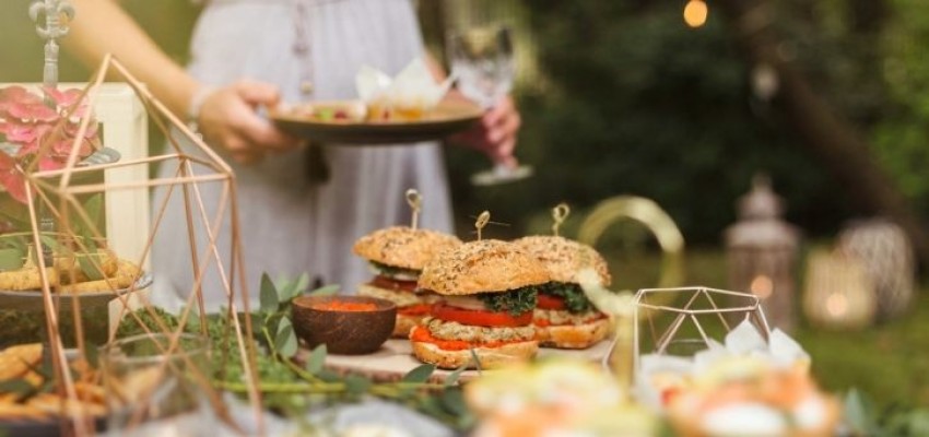 Woman enjoying food at a garden party. 