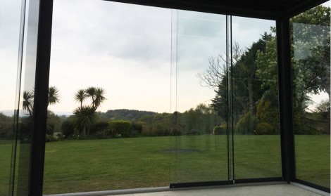 sliding glass walls shown in a luxury pergola